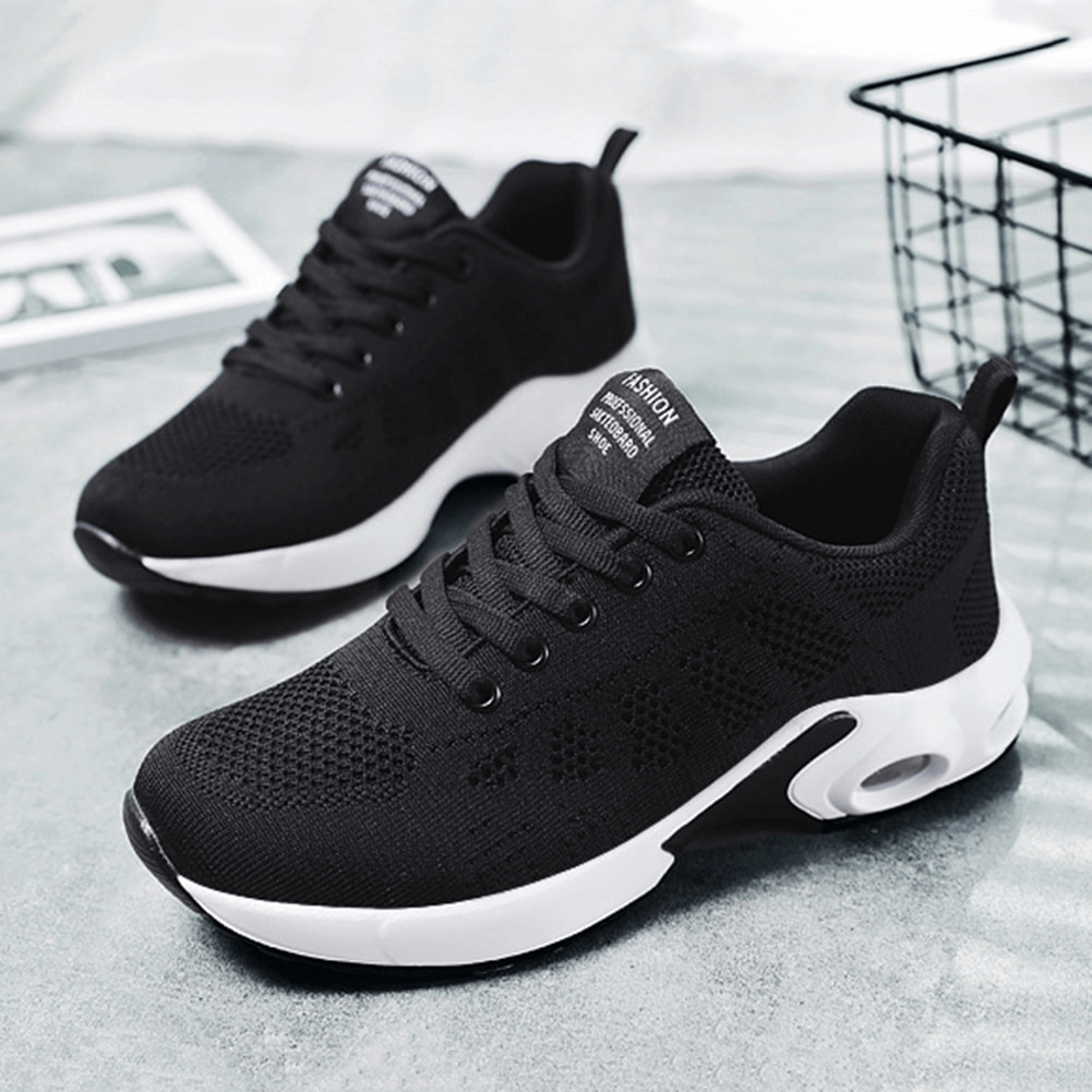 Black breathable wear-resistant lace-up cushioned running shoes on a modern background. Perfect for comfort and stability.